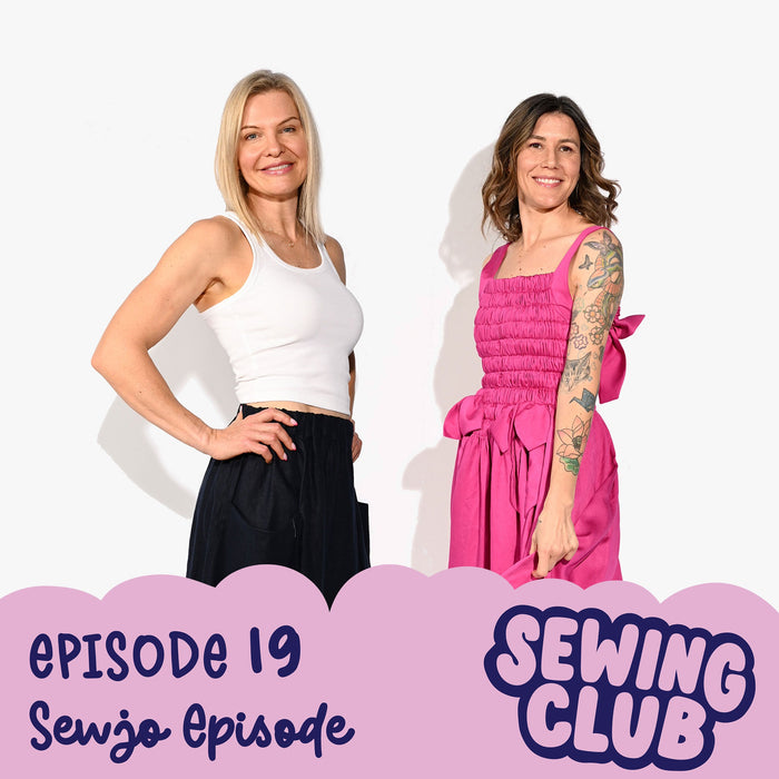 Two women facing the camera wearing hand sewn clothing