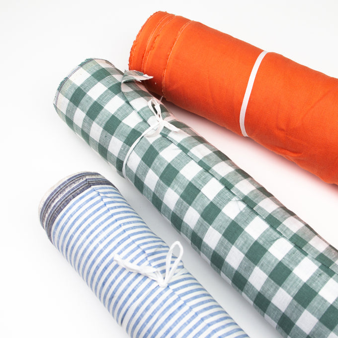 Three rolls of fabric.